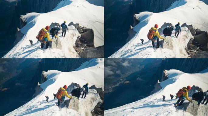 一队登山者在山顶上移动。冬季冒险。视点