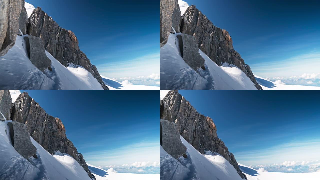 冰山和雪覆盖的尖峰。男子走在陡峭的岩壁上