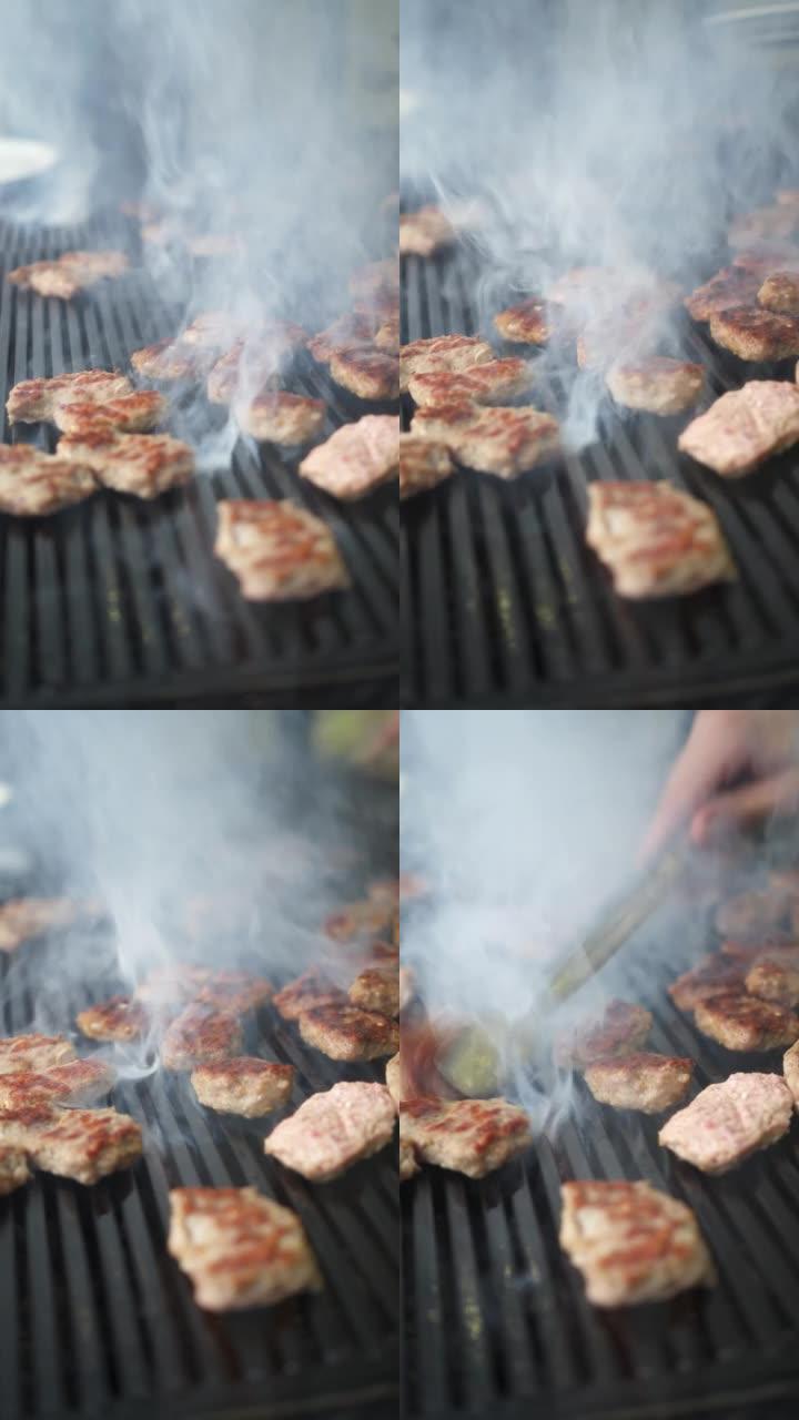 在烤架上烹饪肉类的垂直细节照片