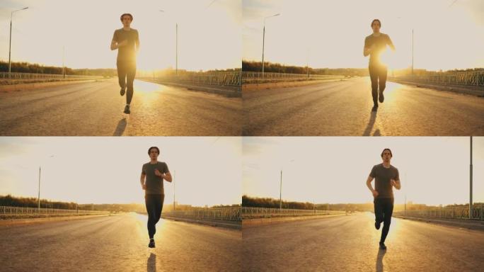 年轻的运动型男子早上独自训练，在晴朗的天气里在路上跑步，锻炼身体