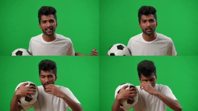 担心不满的中东男子的肖像，用足球说话，打着手势看着绿屏上的相机。失望的年轻球迷在chromakey观