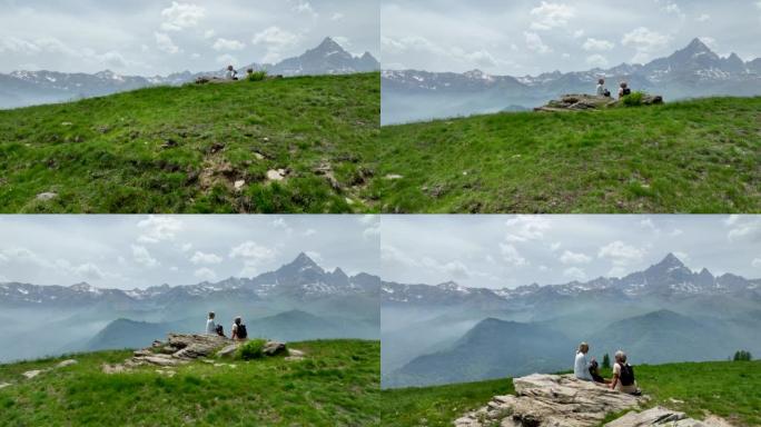 徒步旅行夫妇到达山顶并欣赏山景的鸟瞰图