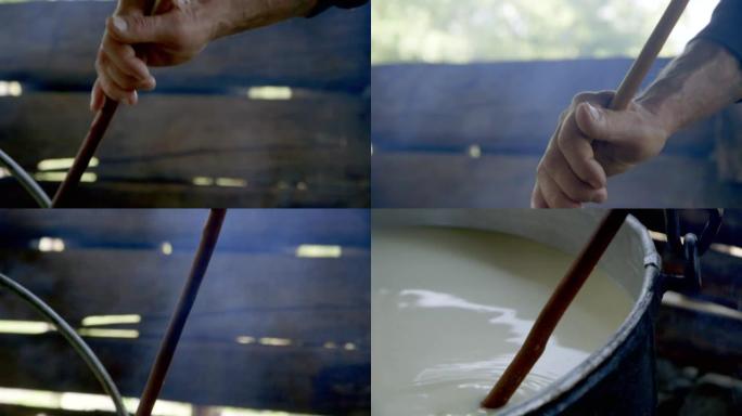 特写镜头将男人的手倾斜到牛奶上，制作奶酪