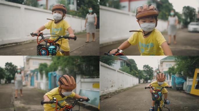 蹒跚学步的小男孩在户外骑自行车玩得开心