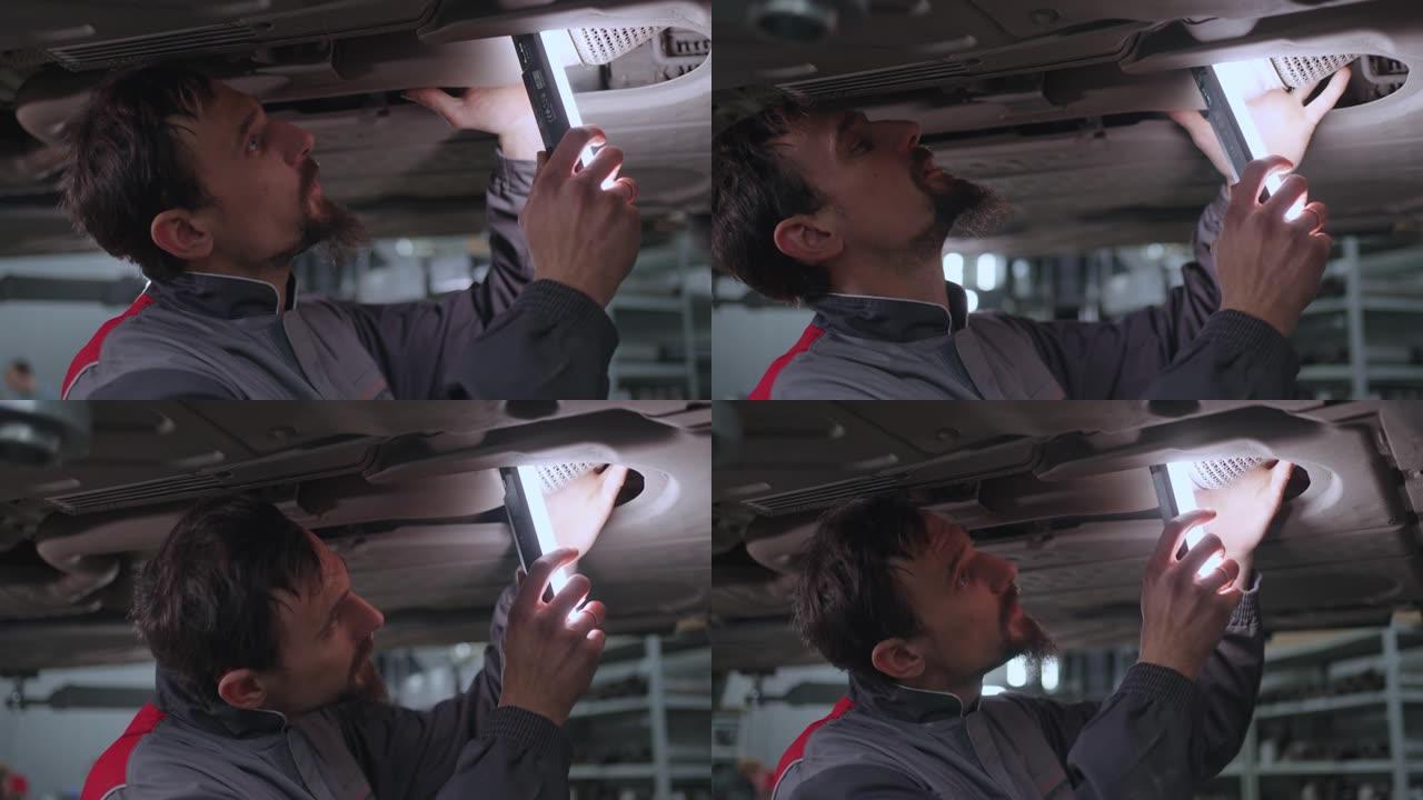一名机械师检查汽车的排气系统