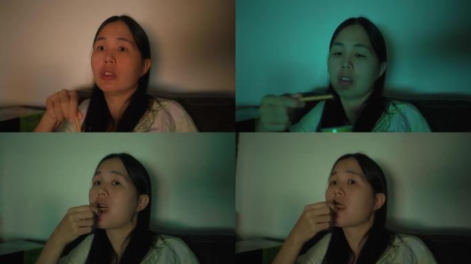 亚洲女性晚上边看电视边吃零食