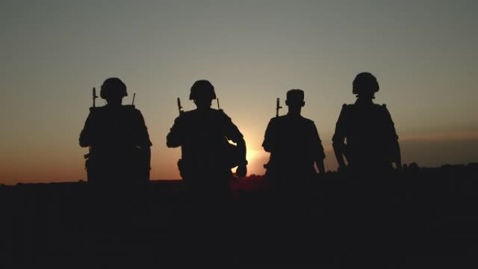 日落时分，带着弹药的狙击手返回家乡的剪影。