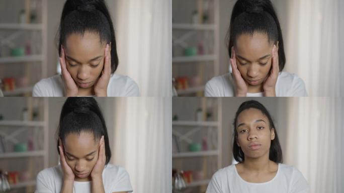 特写不堪重负的疲惫的非洲裔美国女性自由职业者摩擦站在家庭办公室的寺庙。疲倦的年轻女子头痛偏头痛看着相