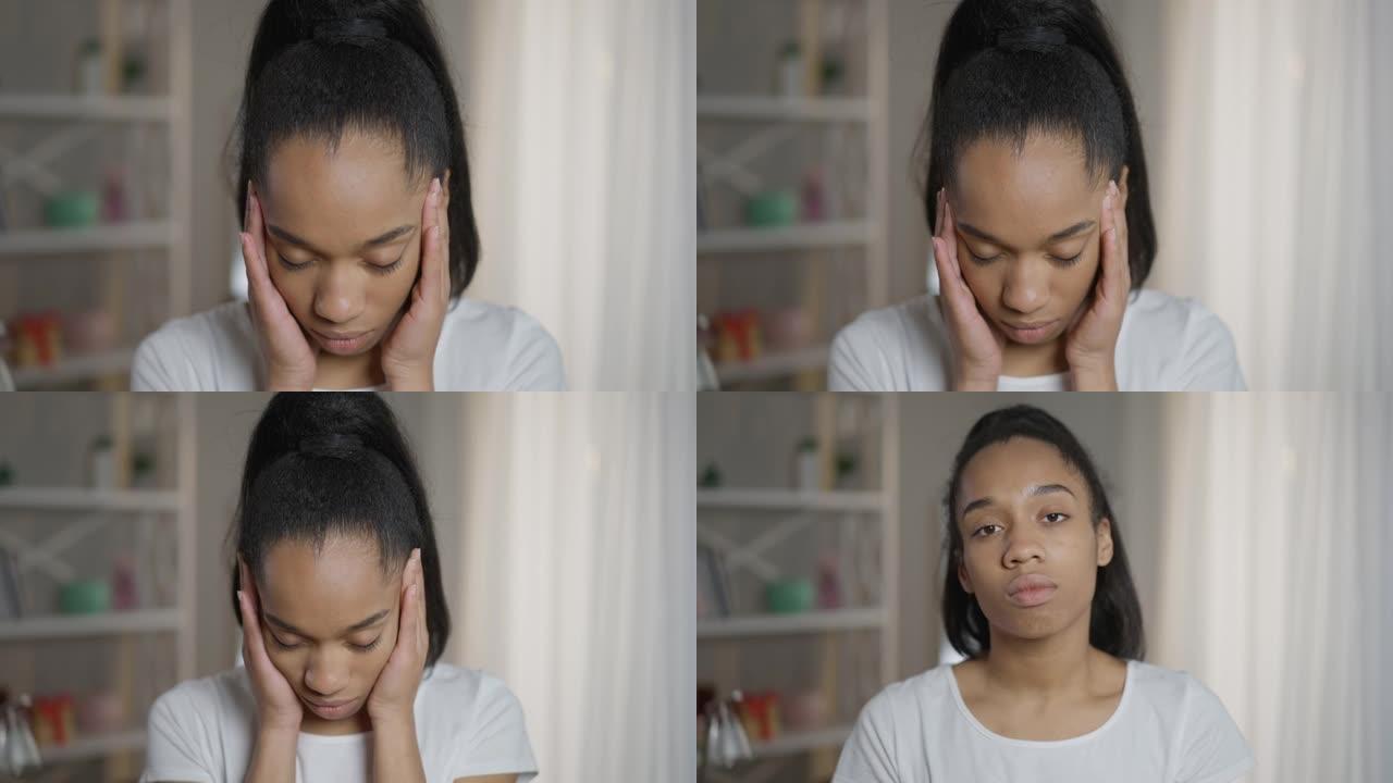 特写不堪重负的疲惫的非洲裔美国女性自由职业者摩擦站在家庭办公室的寺庙。疲倦的年轻女子头痛偏头痛看着相