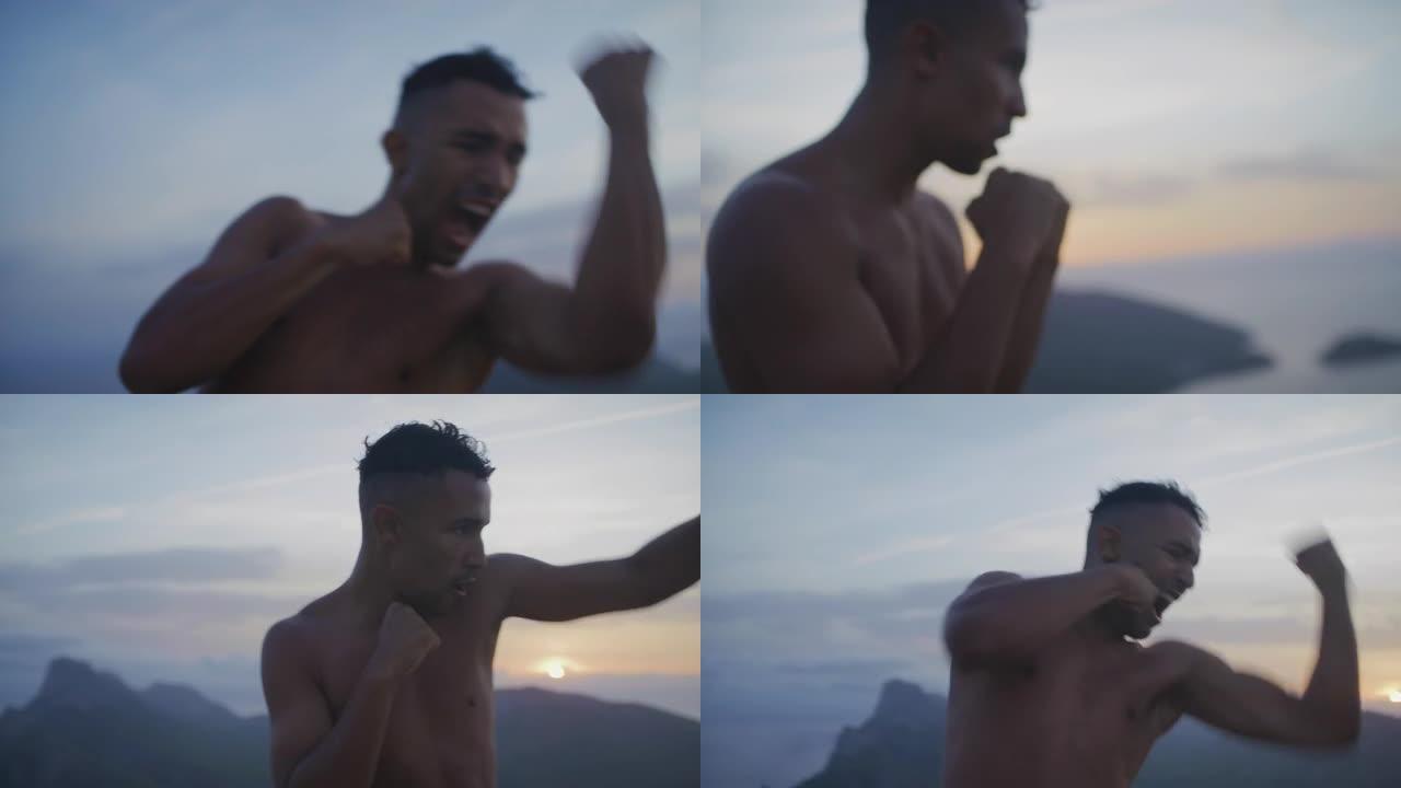 男运动员独自在悬崖上训练。练习拳击动作和拳打