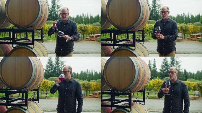 酿酒师使用移液管在桶中取样葡萄酒