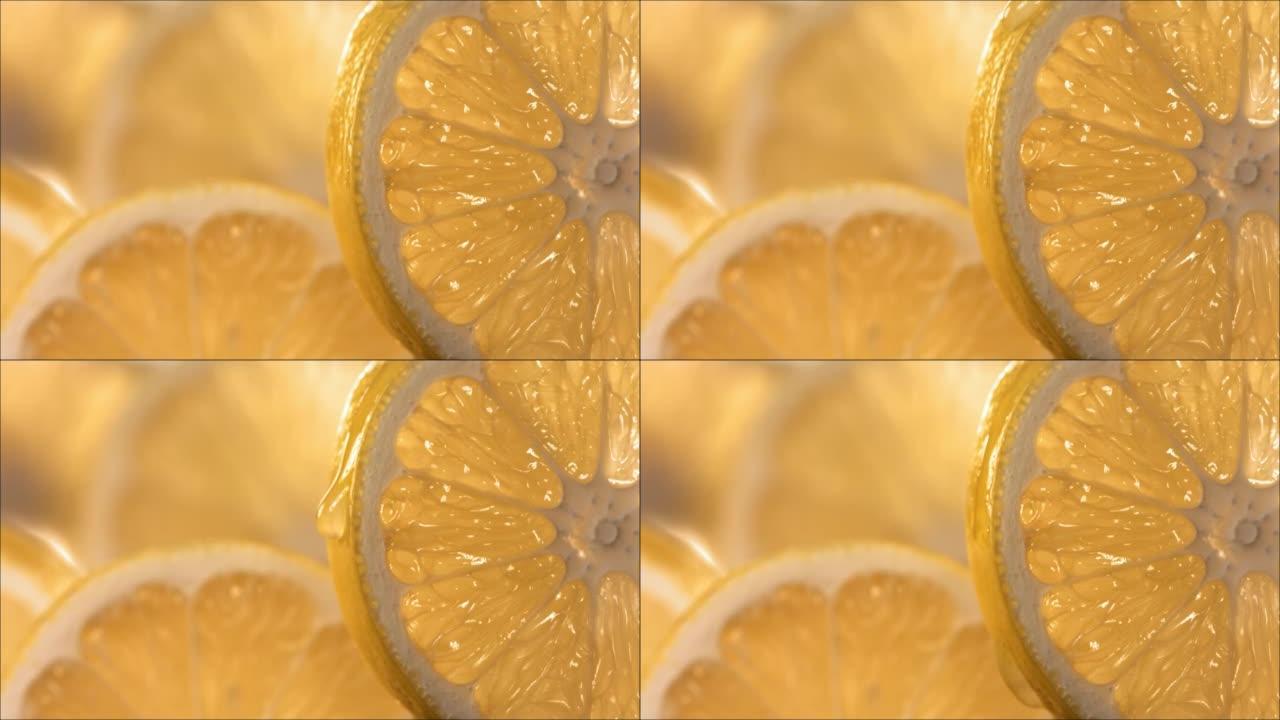 一滴柠檬汁从成熟多汁的柠檬片表面流下。慢动作4K