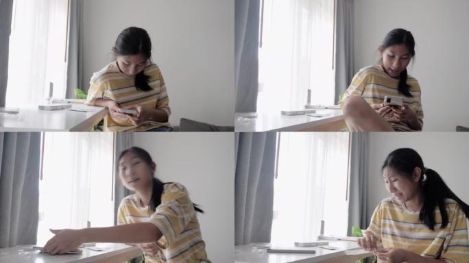 亚洲女孩通过智能手机制作视频，用于在家中使用新型冠状病毒肺炎进行快速测试，然后在在线教室发送给她的老