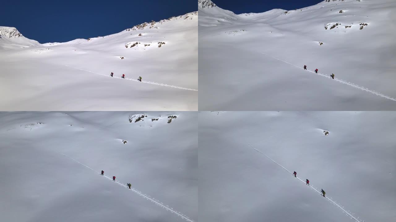 在积雪覆盖的山上的徒步旅行者的空中无人机细节拍摄