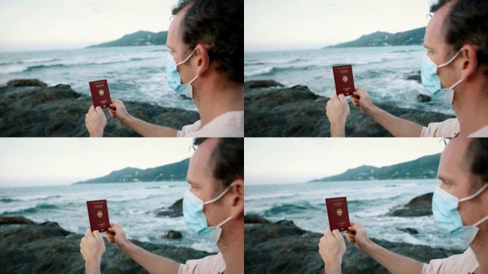 戴口罩的男子在海洋附近持有德国护照