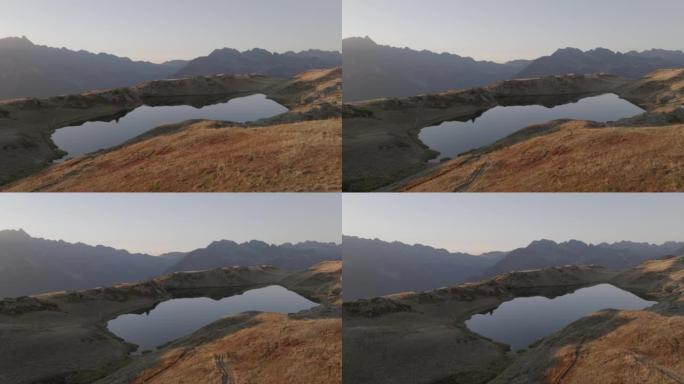 日落时高山湖的空中无人机视图