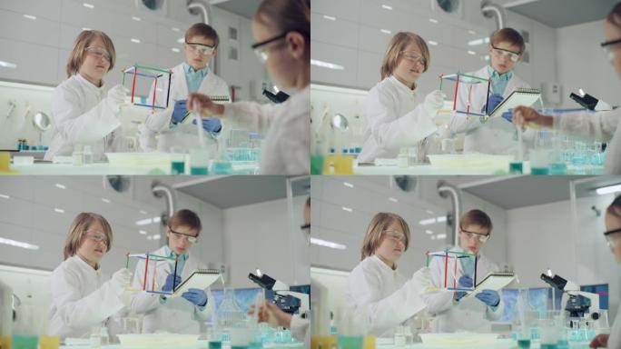 孩子们在实验室进行科学实验。用肥皂泡液体研究表面张力