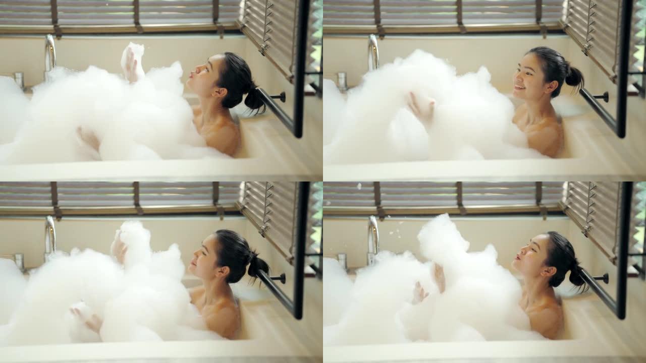 女人在浴缸里泡泡浴。
