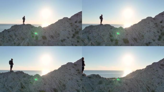男子在岩石脊顶上徒步旅行的鸟瞰图