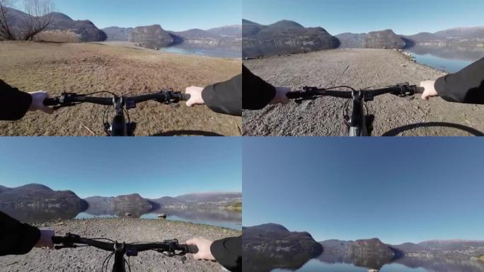 第一人称视角沿着湖边骑电动自行车