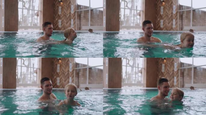 现代化的balneology中心，室内有温泉池，成年男子正在教他的小女儿游泳