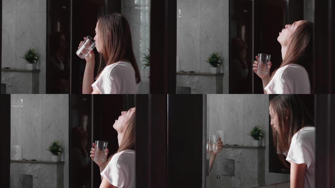 年轻女子用水漱口，看着镜子。