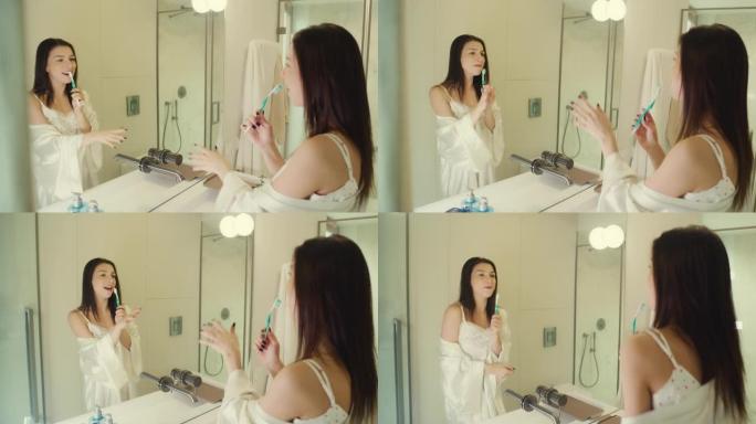 感觉棒极了。女人喜欢早上的浴室活动，在镜子前玩得开心。对着牙刷唱歌