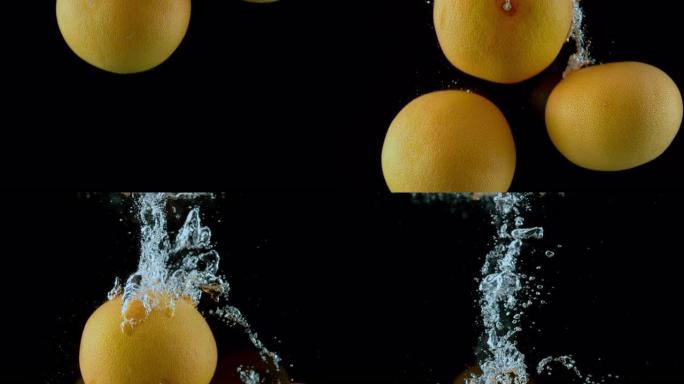 SLO MO LD葡萄柚在黑色背景下落入水中