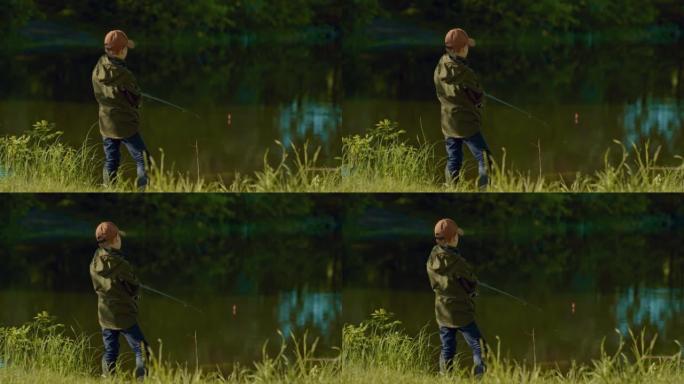 小男孩拿着鱼竿，看着池塘水面上的漂浮，抓鱼，4K，Prores