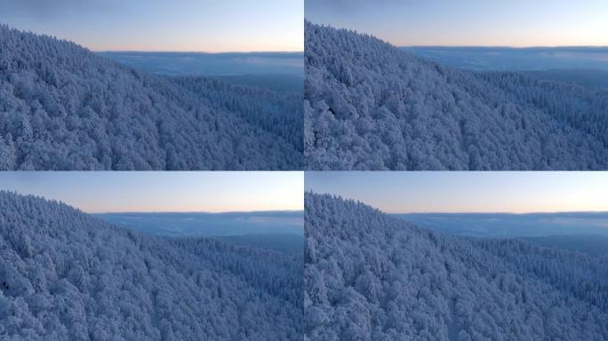 冬季日落滑翔伞时的山脉鸟瞰图
