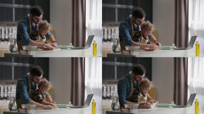 单身父亲和他的小儿子正在家里的厨房里揉面团，爸爸正在学习孩子做饭和娱乐