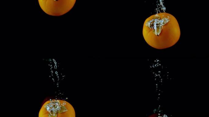 SLO MO LD柿子掉入水中并产生气泡