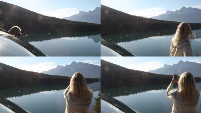 女人打开车门欣赏美丽的山景