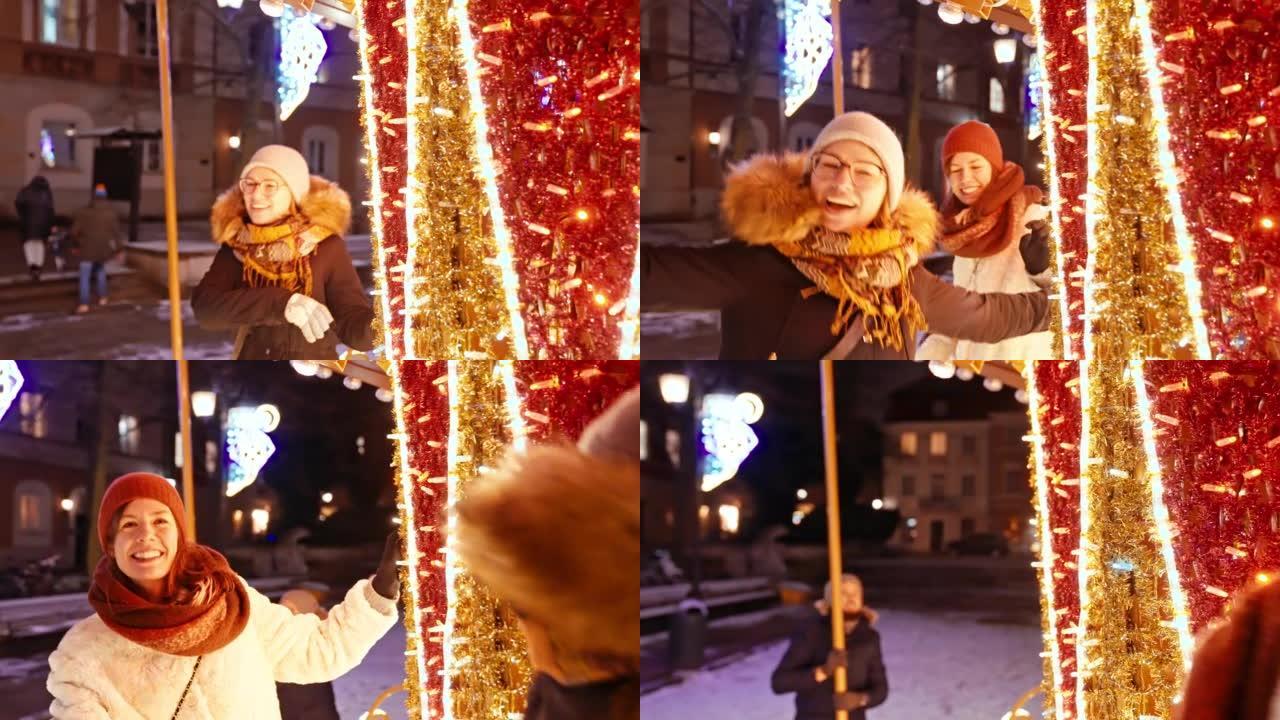 两个女性朋友在一个下雪的圣诞夜慢动作中一起玩旋转木马