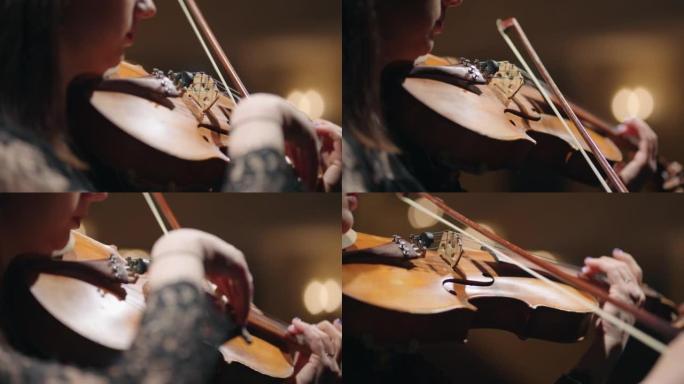 女人手中的老小提琴特写，女音乐家在音乐厅演奏小提琴和排练奏鸣曲