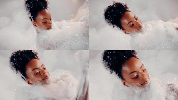 美丽的非洲女人享受着沐浴泡沫覆盖的放松时光。慢动作