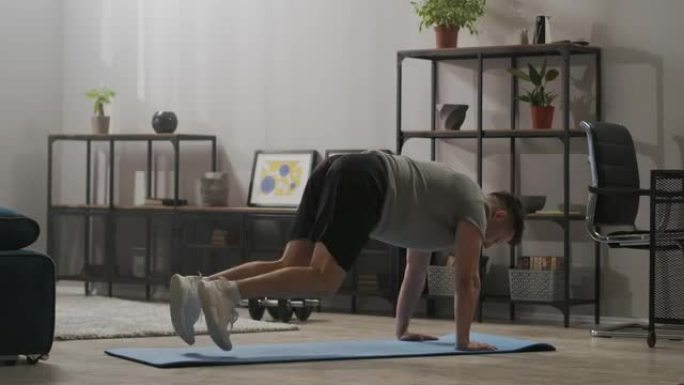 家庭健身房概念，运动员在客厅训练，男子在地板上锻炼身体肌肉，身体状况良好