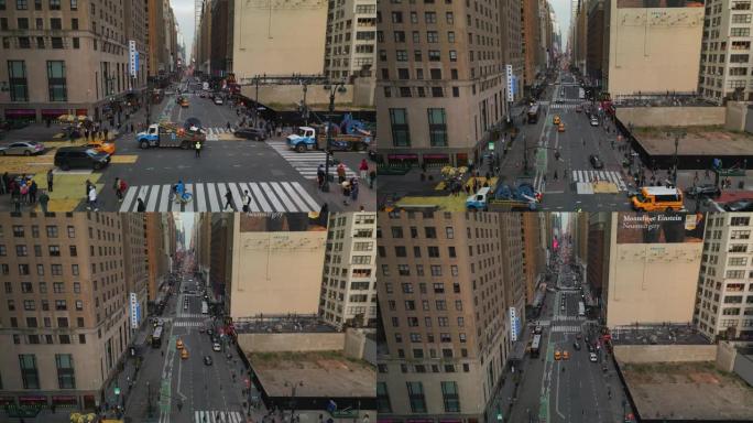 市中心长直街道的空中上升镜头。通过十字路口的车辆和行人。美国纽约市