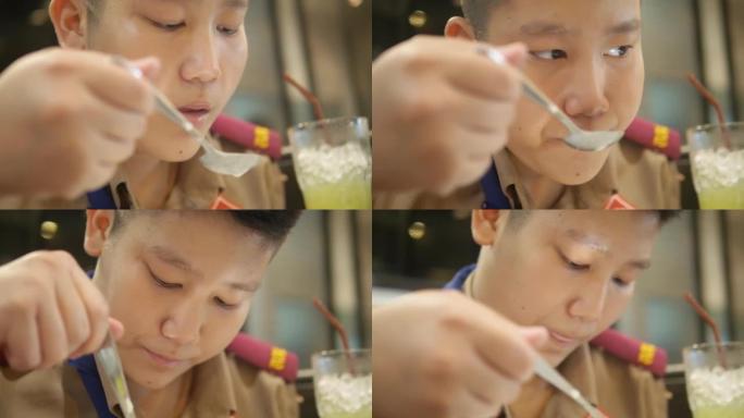 亚洲童子军与家人一起在自助餐厅吃蘑菇汤。