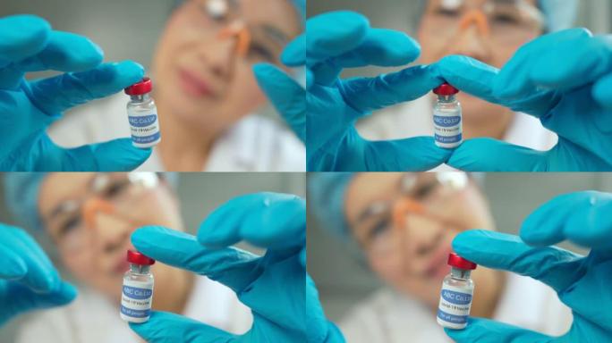 女科学家手持安瓿，新药开发，疫苗接种，新型冠状病毒肺炎冠状病毒疫苗小瓶。