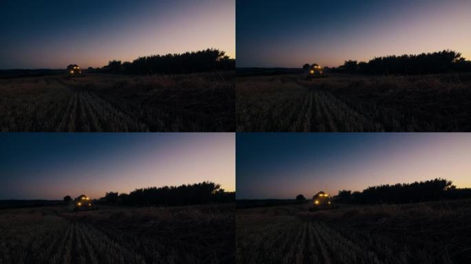 农民驾驶收割机在日落时分在田间收割小麦