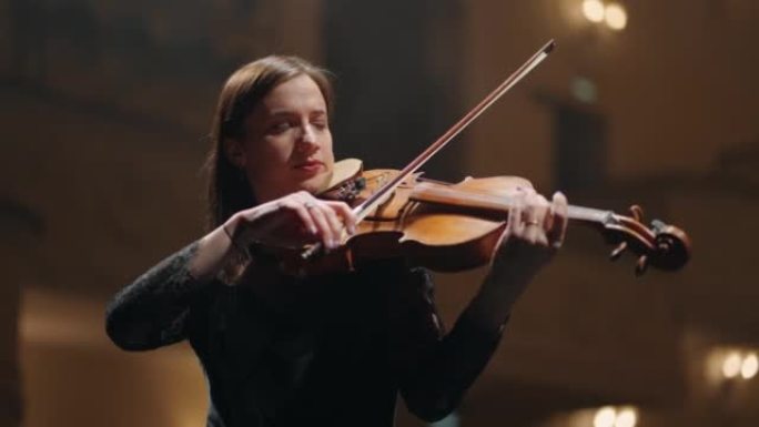 女音乐家在音乐厅现场拉小提琴，爱乐音乐厅女小提琴手的肖像