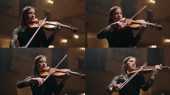 女音乐家在音乐厅现场拉小提琴，爱乐音乐厅女小提琴手的肖像