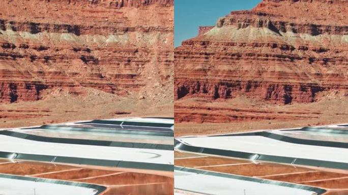 右无人机在犹他州摩押钾矿的停放车辆上平移-垂直
