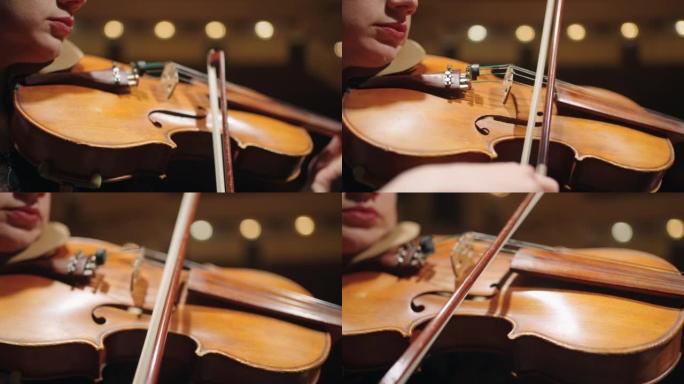 音乐厅音乐会期间女音乐家手中的老小提琴的特写镜头