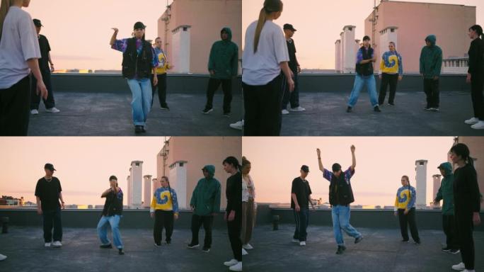 青少年和青年在屋顶上的嘻哈舞蹈派对在日落时分，b-girl正在跳舞