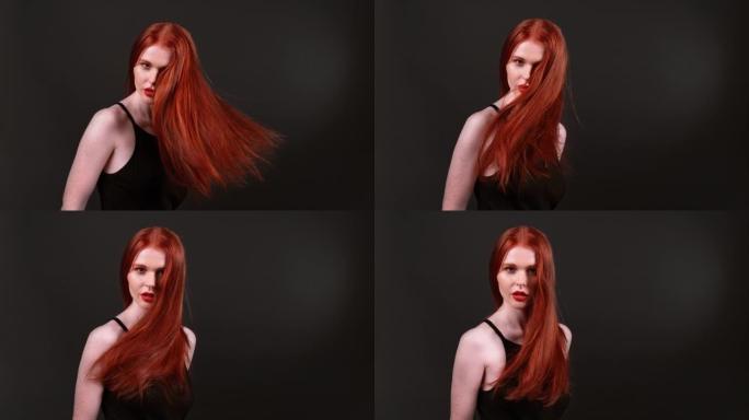 迷人的红发女人在镜头前扔她健康的长发。工作室镜头，超级慢动作