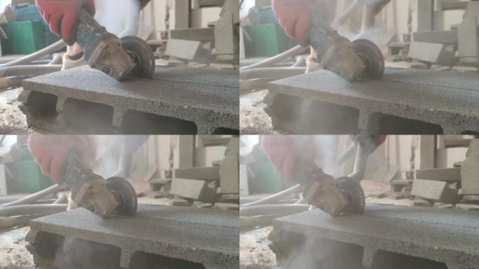 工人用金刚石圆锯片切割混凝土块。