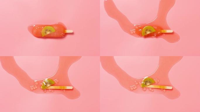 桃子和乌龙味与猕猴桃冰棒切片融化时光倒流在粉红色背景上的俯角视图