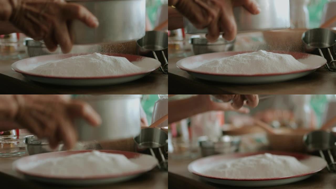 筛选面粉制作自制蛋糕。